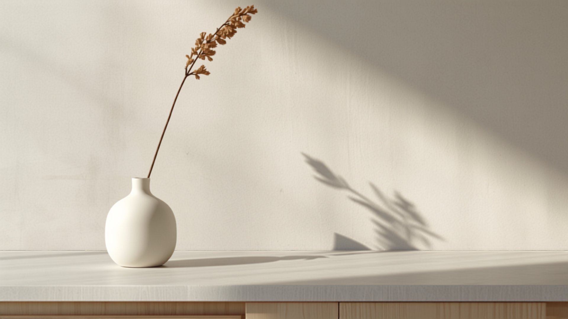 A Japandi cabinet run in pale ash with integrated handles and stone benchtop
